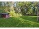 Large backyard with a red shed and lush green grass at 2612 Wicklow Way, Powder Springs, GA 30127