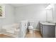 Bathroom with granite countertop, gray cabinets and a bathtub at 2612 Wicklow Way, Powder Springs, GA 30127