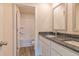 Bathroom with granite countertop, white cabinets, and a bathtub at 1613 Fuma Leaf Way, Mcdonough, GA 30253