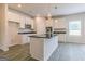 Modern kitchen with island, white cabinets, and granite counters at 1613 Fuma Leaf Way, Mcdonough, GA 30253