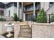 Stone steps lead up to a patio with a brick wall and iron railing at 90 Sheridan Dr, Atlanta, GA 30305