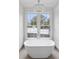 Elegant bathroom with freestanding soaking tub and chandelier at 90 Sheridan Dr, Atlanta, GA 30305