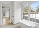Bright bathroom with freestanding tub and large windows at 90 Sheridan Dr, Atlanta, GA 30305