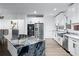 Modern kitchen with white cabinets, stainless steel appliances, and a marble island at 8760 S Mount Dr, Alpharetta, GA 30022