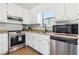 Kitchen with white cabinets, stainless steel appliances, and granite countertops at 204 Holly Creek Way, Woodstock, GA 30188