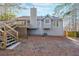 Back exterior of the home with a deck, stairs, and wooded backyard at 242 Viola Dr, Dallas, GA 30157