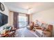 Relaxing bedroom with two comfortable armchairs, a large window, and TV at 242 Viola Dr, Dallas, GA 30157