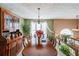 Elegant dining room with chandelier, large windows, and classic hutch at 242 Viola Dr, Dallas, GA 30157