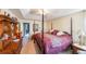 Large main bedroom with four-poster bed, dresser, and carpet flooring at 242 Viola Dr, Dallas, GA 30157