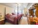 Spacious main bedroom featuring a four-poster bed, dresser, and carpet flooring at 242 Viola Dr, Dallas, GA 30157
