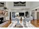 Open living room with a stone fireplace, hardwood floors, and a view of a second-story balcony at 3350 Vista Creek Dr, Dacula, GA 30019