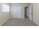 Well-lit bedroom with grey carpet, closet, and hallway access at 3390 Glenview Sw Cir, Atlanta, GA 30331