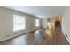 Large living room with dark vinyl flooring, and a staircase at 3390 Glenview Sw Cir, Atlanta, GA 30331