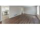 Open living room with dark vinyl flooring and kitchen view at 3390 Glenview Sw Cir, Atlanta, GA 30331