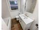Updated bathroom with white vanity, modern fixtures, and grey tile at 522 Jo Ann Se Dr, Marietta, GA 30067