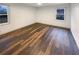 Spacious bedroom with wood-look vinyl flooring and multiple windows at 522 Jo Ann Se Dr, Marietta, GA 30067