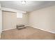 Spacious finished basement with neutral carpeting and ample natural light at 6979 Bruce Cir, Lithonia, GA 30058
