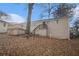 Back of house, showing deck and sloped backyard with large tree at 6979 Bruce Cir, Lithonia, GA 30058