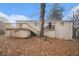 Back of house, showing deck and sloped backyard with large tree at 6979 Bruce Cir, Lithonia, GA 30058