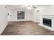 Living room featuring hardwood floors, fireplace, and built-in shelving at 4701 Cedar Dr, Loganville, GA 30052