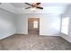 Main bedroom with carpet and access to sitting area at 6131 Windflower Dr, Powder Springs, GA 30127