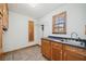 Laundry room with wood cabinets, tile floor and a utility sink at 289 Barn Rd, Canton, GA 30115