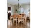 Formal dining room with chandelier and hardwood floors at 3658 Clark Hill Way, Buford, GA 30519