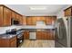 Modern kitchen with wood cabinets and stainless steel appliances at 4859 W Park Cir, Atlanta, GA 30349