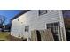 Side view of a two-story house with light gray vinyl siding and a damaged fence at 1041 Heritage Valley Rd, Norcross, GA 30093
