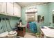 Laundry room with light green walls and built in cabinets at 1526 N Cherokee N Rd, Social Circle, GA 30025