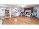 Spacious living room with hardwood floors, brick fireplace, and built-in shelving at 1526 N Cherokee N Rd, Social Circle, GA 30025