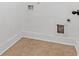 Small laundry room with tile flooring and built-in cabinets at 7601 Watson Cir, Locust Grove, GA 30248