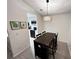 Dining area with a view of the kitchen; modern light fixture and wine storage in table at 1218 Mcclelen Way, Decatur, GA 30033