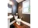 Small bathroom with dark-painted walls and pedestal sink at 2439 Muirfield Pl, Atlanta, GA 30337