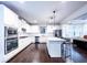 Modern kitchen with white cabinets and granite island at 2439 Muirfield Pl, Atlanta, GA 30337