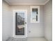 Front door entry with storm door and small window, a welcome mat is placed on the floor at 2680 Senegal Way # 88, Atlanta, GA 30331