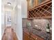 Butlers pantry with granite countertops and wine rack at 2013 Hidden Aly, Alpharetta, GA 30009