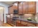 Kitchen with granite countertops and wood cabinets at 2013 Hidden Aly, Alpharetta, GA 30009