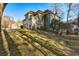 Home's side exterior showing the grassy sloped lot, garage, and trees at 5712 Overlook Circle, Powder Springs, GA 30127