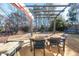 Backyard with covered patio, dining area, and wooded view at 6620 Grand Magnolia Dr, Sugar Hill, GA 30518