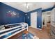 bedroom with blue walls, space decor, and a white loft bed at 6620 Grand Magnolia Dr, Sugar Hill, GA 30518