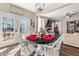 Dining area with a black table, white chairs, and French doors leading to the backyard at 6620 Grand Magnolia Dr, Sugar Hill, GA 30518