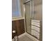 Bathroom with shower stall, wood-look walls, and gray tile floor at 1250 Olympic Dr, Oxford, GA 30054