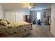 Spacious bedroom with carpeted floor, ceiling fan, and ample closet space at 1250 Olympic Dr, Oxford, GA 30054