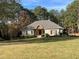 Brick ranch home with large yard and mature trees at 1250 Olympic Dr, Oxford, GA 30054