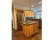 Kitchen island with sink, stainless steel refrigerator, and wood cabinets at 1250 Olympic Dr, Oxford, GA 30054