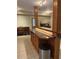 Kitchen boasts a breakfast bar with granite countertop and wood cabinets at 1250 Olympic Dr, Oxford, GA 30054