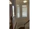 Elegant staircase with wood railing and neutral wall colors at 1250 Olympic Dr, Oxford, GA 30054