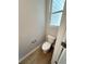 Small powder room with toilet and wood-look flooring at 1825 Harmony Trce, Lithonia, GA 30058