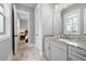 Bathroom with granite countertop, gray cabinets, and view of bedroom at 655 Flower Farm Dr, Acworth, GA 30101